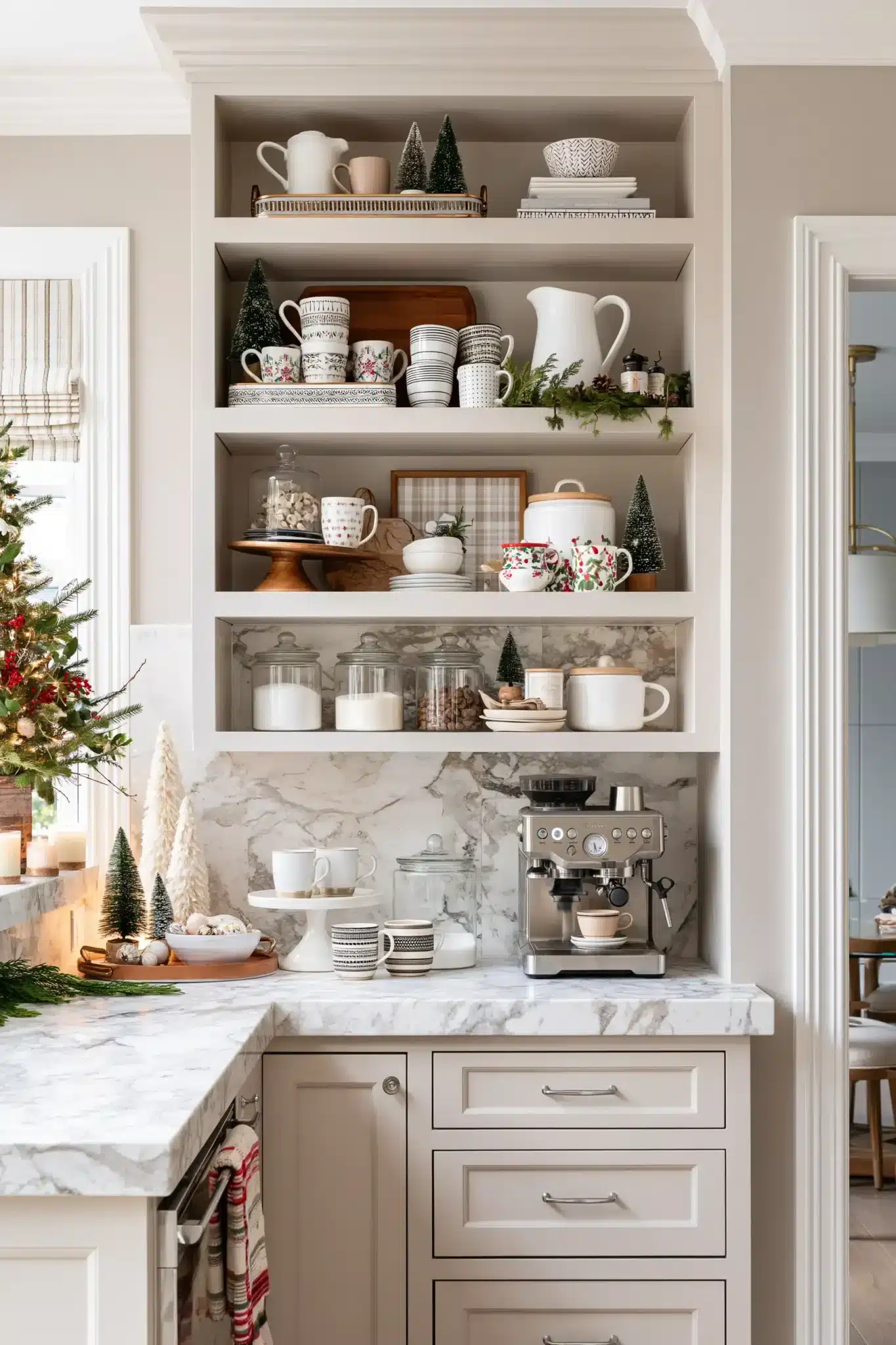A festive coffee station styled with mugs, greenery, and Christmas decor